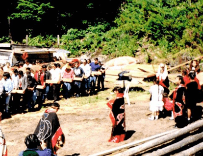 People carrying a totem pole