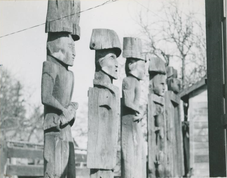 Side view of five house posts lined up.