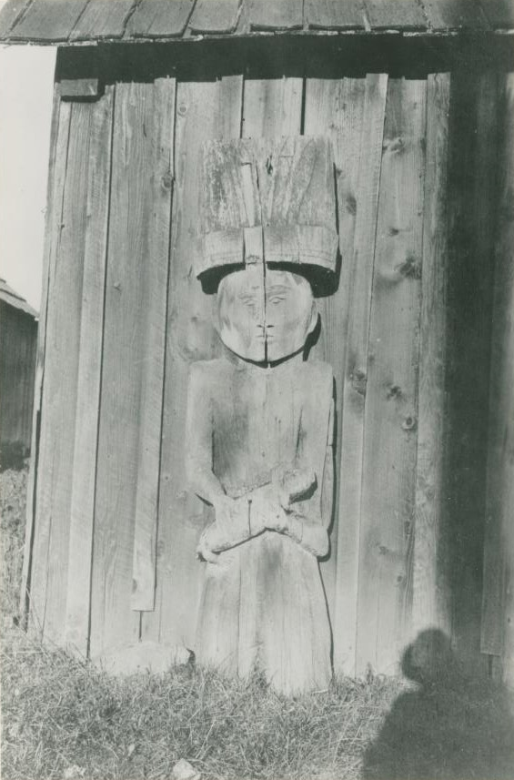 Close-up view of a carved house post.