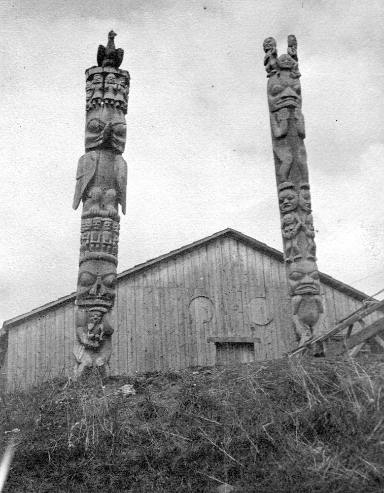 Two poles standing in front of a house.