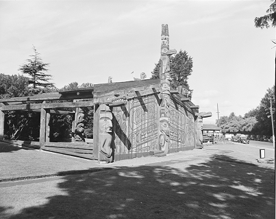 House posts in Thunderbird Park standing at the front corners of a Haida house