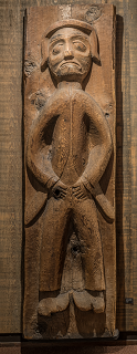 House post with carved human figure displayed