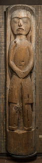 House post with carved human figure displayed in the museum collection.