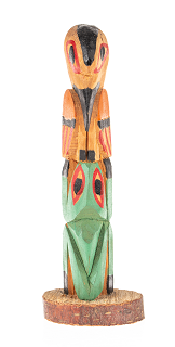 Miniature totem depicting a frog and bird