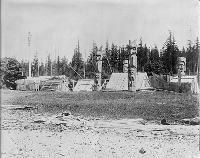 Group of totems and markers in front of houses