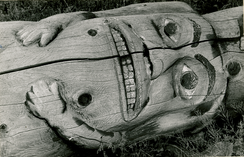 Detailed view of totem pole lying on its side