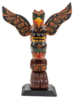 Small carved totem depicting a thunderbird and bear