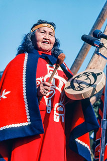 Chiefin ceremonial garb and blank bangs drum